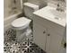 A bathroom features a vanity with white cabinets, a white toilet, and decorative tile flooring at 1651 Massachusetts Sw Ave # 1, Marietta, GA 30008