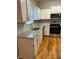 Modern kitchen with granite countertops, white cabinets, and stainless steel appliances at 1651 Massachusetts Sw Ave # 1, Marietta, GA 30008