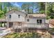 The back of this home features a large deck and balcony and sliding glass doors at 3050 Woodland Nw Dr, Kennesaw, GA 30152