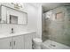 Updated bathroom features a stylish vanity, modern fixtures, and a beautifully tiled walk-in shower at 3050 Woodland Nw Dr, Kennesaw, GA 30152