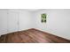 This sunny bedroom has new floors and lots of natural light from the bright window and exterior door at 3050 Woodland Nw Dr, Kennesaw, GA 30152