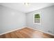 Bright bedroom with light hardwood flooring and natural light from the window at 3050 Woodland Nw Dr, Kennesaw, GA 30152