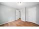 Simple bedroom with hardwood floors and two white doors at 3050 Woodland Nw Dr, Kennesaw, GA 30152