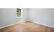 Cozy room boasts new flooring and a bright window, offering an abundance of natural light at 3050 Woodland Nw Dr, Kennesaw, GA 30152