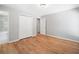 Cozy bedroom featuring hardwood floors, a walk-in closet, and an ensuite bathroom with a tiled shower at 3050 Woodland Nw Dr, Kennesaw, GA 30152