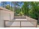 Outdoor deck made from light wood offers a serene view of the wooded area at 3050 Woodland Nw Dr, Kennesaw, GA 30152
