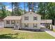 Inviting home with mature lawn, traditional shutters, and balcony over the drive at 3050 Woodland Nw Dr, Kennesaw, GA 30152