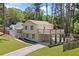 Charming home with a balcony over the drive, landscaped front yard and fresh green grass at 3050 Woodland Nw Dr, Kennesaw, GA 30152