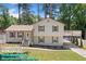 Remodeled two-story home boasting a welcoming front yard, charming shutters and an inviting covered parking area at 3050 Woodland Nw Dr, Kennesaw, GA 30152