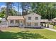 Charming home with a well-manicured lawn, welcoming entrance, convenient covered parking, and picturesque natural surroundings at 3050 Woodland Nw Dr, Kennesaw, GA 30152