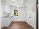 Well-lit laundry room features new cabinetry, granite countertops, and modern flooring at 3050 Woodland Nw Dr, Kennesaw, GA 30152