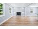 Living room featuring recessed lighting, large windows, a sleek fireplace, and modern vinyl plank flooring at 3050 Woodland Nw Dr, Kennesaw, GA 30152