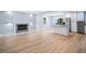 Open concept kitchen and living room featuring stainless appliances, island, fireplace and vinyl plank flooring at 3050 Woodland Nw Dr, Kennesaw, GA 30152