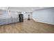 Finished basement featuring gray cabinets with granite countertops, a black refrigerator, and an elliptical machine at 4035 Pinebrook Cir, Cumming, GA 30028