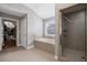 This spacious bathroom features a soaking tub, separate shower, and neutral tile at 4035 Pinebrook Cir, Cumming, GA 30028