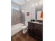 Clean bathroom with tub, shower, dark cabinets, and a dark countertop at 4035 Pinebrook Cir, Cumming, GA 30028