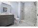 Bathroom with grey vanity, toilet, and tiled walk-in shower at 4035 Pinebrook Cir, Cumming, GA 30028