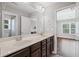 Bright bathroom features a double vanity, a large mirror, and access to an additional bathroom and bedroom at 4035 Pinebrook Cir, Cumming, GA 30028