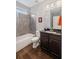 Bathroom featuring a tile surround tub and a vanity with dark wood cabinets at 4035 Pinebrook Cir, Cumming, GA 30028