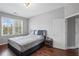 This bedroom is bright and features a large bed, gleaming wood floors, and natural light at 4035 Pinebrook Cir, Cumming, GA 30028
