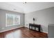 Comfortable bedroom features hardwood floors, abundant natural light, and neutral color scheme at 4035 Pinebrook Cir, Cumming, GA 30028