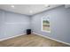 Bedroom with wood floors, light blue walls, and a view from the window at 4035 Pinebrook Cir, Cumming, GA 30028