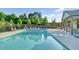 Beautiful community pool with ample seating, pergolas, and lush landscaping for relaxation at 4035 Pinebrook Cir, Cumming, GA 30028