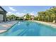 Sparkling community pool area with lounge chairs for relaxing in the sun surrounded by a black fence at 4035 Pinebrook Cir, Cumming, GA 30028
