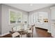 Bright dining area with a glass table, hardwood floors, and access to the outdoor deck at 4035 Pinebrook Cir, Cumming, GA 30028