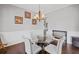 Elegant dining room featuring a glass table, chandelier, and detailed wainscoting at 4035 Pinebrook Cir, Cumming, GA 30028
