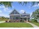 Charming two-story home with a well-manicured lawn, colorful landscaping, and covered front porch at 4035 Pinebrook Cir, Cumming, GA 30028