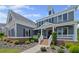 Two-story home with landscaped yard, inviting porch, brick accents, and manicured garden beds at 4035 Pinebrook Cir, Cumming, GA 30028