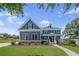 Beautiful two-story blue house with landscaped front yard and inviting entryway, offering charm and curb appeal at 4035 Pinebrook Cir, Cumming, GA 30028