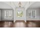 Inviting foyer with hardwood floors, classic millwork, arched openings, and bright, natural light at 4035 Pinebrook Cir, Cumming, GA 30028