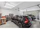 Well-organized garage with a black car parked inside, storage shelves, and overhead lighting at 4035 Pinebrook Cir, Cumming, GA 30028
