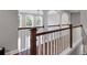 Open hallway featuring beautiful wood and white railings with natural light at 4035 Pinebrook Cir, Cumming, GA 30028