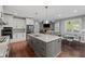 Open kitchen with stainless appliances, expansive island, and adjacent living space at 4035 Pinebrook Cir, Cumming, GA 30028