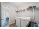 This functional laundry room includes modern washer, dryer, and storage shelves at 4035 Pinebrook Cir, Cumming, GA 30028