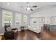 Open-concept living area with hardwood floors and a view into the kitchen with bar seating at 4035 Pinebrook Cir, Cumming, GA 30028