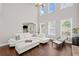 Bright living room featuring a fireplace, large windows, and a comfortable seating area at 4035 Pinebrook Cir, Cumming, GA 30028