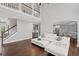 Bright open-concept living room with staircase, hardwood floors, and a view of the kitchen at 4035 Pinebrook Cir, Cumming, GA 30028