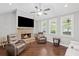 Inviting living room with a stone fireplace, plush seating, and a ceiling fan at 4035 Pinebrook Cir, Cumming, GA 30028