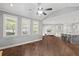 Open concept living room with windows, hardwood floors, and seamless flow into the kitchen at 4035 Pinebrook Cir, Cumming, GA 30028