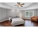 Spacious main bedroom with tray ceilings, hardwood floors, and a comfortable sitting area at 4035 Pinebrook Cir, Cumming, GA 30028