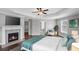 Spacious main bedroom features fireplace, white trim, and ceiling fan at 4035 Pinebrook Cir, Cumming, GA 30028