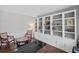 Stylish home office with custom built-in shelving, hardwood floors, and cozy seating area at 4035 Pinebrook Cir, Cumming, GA 30028