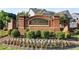 A brick community entrance sign with beautiful landscaping and flowers at 4035 Pinebrook Cir, Cumming, GA 30028