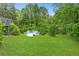 Expansive backyard with lush green lawn and inviting above-ground pool, perfect for summer fun at 1105 Sallete Ct, Marietta, GA 30066