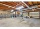 Unfinished basement with exposed duct work and multiple garage doors at 1105 Sallete Ct, Marietta, GA 30066