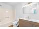 Modern bathroom features a wood vanity, gold fixtures, mirror, and shower/tub combo at 1105 Sallete Ct, Marietta, GA 30066